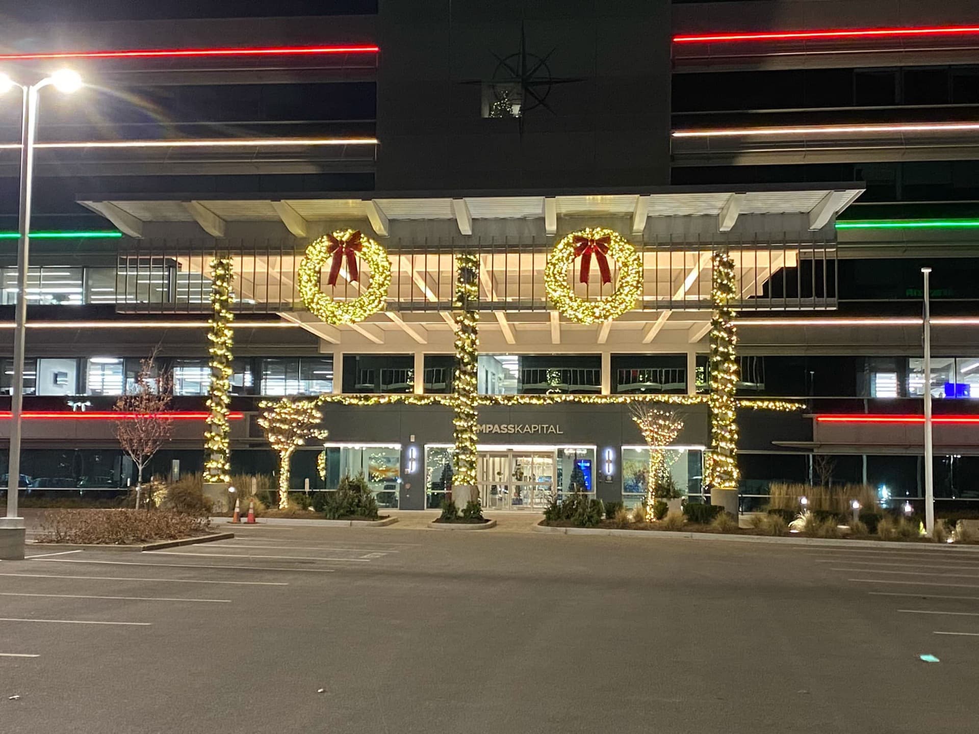 Commercial office building entrance with wreaths and garland holiday lighting